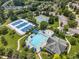 Overhead view of community amenities: a pool, tennis courts, and clubhouse nestled among lush greenery at 306 Berlin Way, Morrisville, NC 27560