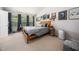 Cozy bedroom featuring a vaulted ceiling, three windows, and stylish decor at 306 Berlin Way, Morrisville, NC 27560
