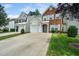 Street view of homes displaying their manicured lawns, driveways, and welcoming facades at 306 Berlin Way, Morrisville, NC 27560
