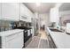 Well-lit kitchen featuring stainless steel appliances, white cabinets, and stylish backsplash at 306 Berlin Way, Morrisville, NC 27560