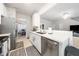 Bright kitchen with stainless steel appliances, sleek countertops, and a view into the living area at 306 Berlin Way, Morrisville, NC 27560