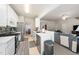 Clean kitchen offering stainless steel appliances, white cabinetry, and ample countertop space at 306 Berlin Way, Morrisville, NC 27560
