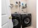 Convenient laundry room with modern Samsung washer and dryer and ample overhead storage shelving at 306 Berlin Way, Morrisville, NC 27560