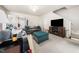Open-concept living room with a large TV, cozy seating, and a modern entertainment center at 306 Berlin Way, Morrisville, NC 27560