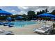 A spacious community pool is surrounded by lounge chairs and umbrellas for relaxation and enjoyment at 306 Berlin Way, Morrisville, NC 27560