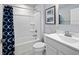 Well-lit bathroom with vanity, toilet, and tub with shower at 311 Rothbury Ct, Sanford, NC 27330