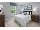 Bright bedroom with a window, carpet floors, bed, and decor at 311 Rothbury Ct, Sanford, NC 27330