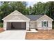 Charming one-story home featuring an attached two-car garage and neutral siding, awaiting your personal touch at 311 Rothbury Ct, Sanford, NC 27330