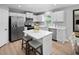Bright kitchen featuring white cabinets, stainless steel appliances, and an island with seating at 311 Rothbury Ct, Sanford, NC 27330