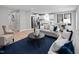 Inviting living room showcases stylish furnishings, a large area rug, and a seamless transition to the kitchen and dining areas at 311 Rothbury Ct, Sanford, NC 27330