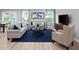 Elegant living room featuring a blue area rug, comfortable seating, natural light and sleek decor at 311 Rothbury Ct, Sanford, NC 27330