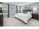 Serene main bedroom features ample natural light, soft carpeting and stylish décor at 311 Rothbury Ct, Sanford, NC 27330
