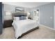 Cozy main bedroom offers a spacious layout, neutral tones, coordinated décor and an en suite bathroom at 311 Rothbury Ct, Sanford, NC 27330