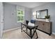 Functional home office space with a modern desk, storage cabinet, and large window offering natural light at 311 Rothbury Ct, Sanford, NC 27330