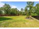 Home's large backyard is enclosed with a privacy fence and mature landscaping at 315 Watchmen Ln, Cameron, NC 28326