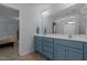 Bathroom features a framed vanity mirror, double sinks, and blue cabinets at 315 Watchmen Ln, Cameron, NC 28326