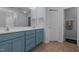 Bathroom featuring double vanity, framed mirror, linen closet, and ceramic tile flooring at 315 Watchmen Ln, Cameron, NC 28326