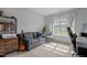 Bright bedroom with a cozy couch and work space bathed in natural light at 315 Watchmen Ln, Cameron, NC 28326