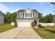 Charming two-story home with a two-car garage and a well-manicured lawn with an inviting entrance at 315 Watchmen Ln, Cameron, NC 28326