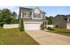 Charming two-story home with a two-car garage and manicured lawn with mature landscaping at 315 Watchmen Ln, Cameron, NC 28326