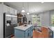 Open kitchen featuring a large island, stainless steel refrigerator, and adjacent dining area at 315 Watchmen Ln, Cameron, NC 28326