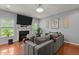 Inviting living room with a fireplace and a cozy gray sectional sofa at 315 Watchmen Ln, Cameron, NC 28326