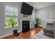Bright living room with a fireplace and large windows offering natural light at 315 Watchmen Ln, Cameron, NC 28326