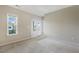 Neutral bedroom featuring plush carpeting, crown molding, and lots of natural light from the window and french doors at 316 Levi Ln, Wake Forest, NC 27587