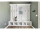 Hallway featuring custom storage and display area, with bench and coat hooks at 316 Levi Ln, Wake Forest, NC 27587