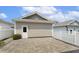 Detached garage with white door and siding, next to a paved area and white fence at 316 Levi Ln, Wake Forest, NC 27587
