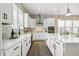 Bright kitchen featuring white cabinetry, stainless appliances, and kitchen island at 316 Levi Ln, Wake Forest, NC 27587