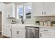 Bright kitchen area featuring white cabinetry, a farmhouse sink, and modern faucet at 316 Levi Ln, Wake Forest, NC 27587