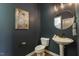 Stylish powder room featuring modern vanity and wall art in a contemporary setting at 316 Levi Ln, Wake Forest, NC 27587