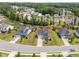Aerial view of gray siding homes in a community with mature trees, offering curb appeal and neighborhood charm at 33 E Ravano Dr, Clayton, NC 27527