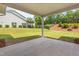 View from the home's covered patio into the grassy backyard at 33 E Ravano Dr, Clayton, NC 27527