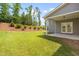 View of grassy backyard with landscaping and a patio at 33 E Ravano Dr, Clayton, NC 27527