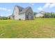 Lush backyard with newly installed air conditioner, offers a large green area for activities and entertaining at 33 E Ravano Dr, Clayton, NC 27527