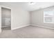 Cozy bedroom with neutral carpet and doorway to large walk-in closet at 33 E Ravano Dr, Clayton, NC 27527