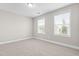 Inviting bedroom with plush carpet and two bright windows offering natural light at 33 E Ravano Dr, Clayton, NC 27527