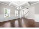 Formal dining room featuring coffered ceilings, hardwood floors, and wainscoting at 33 E Ravano Dr, Clayton, NC 27527