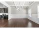 Dining room features wood floors, coffered ceiling, and view of kitchen at 33 E Ravano Dr, Clayton, NC 27527