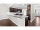 Modern kitchen with dark cabinets, granite countertops, stainless steel appliances and attached breakfast bar at 33 E Ravano Dr, Clayton, NC 27527