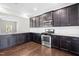 Updated kitchen with stainless appliances, dark cabinets, granite counters, and hardwood flooring at 33 E Ravano Dr, Clayton, NC 27527