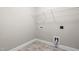 Practical laundry room with essential hookups and overhead wire shelving at 33 E Ravano Dr, Clayton, NC 27527