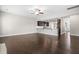 Bright living room with a ceiling fan and dark hardwood flooring that opens to the eat-in kitchen at 33 E Ravano Dr, Clayton, NC 27527