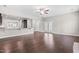 Open-concept living room with hardwood floors seamlessly connects to the adjacent kitchen and dining area at 33 E Ravano Dr, Clayton, NC 27527