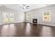 Bright living room featuring fireplace, wood floors, and double glass doors at 33 E Ravano Dr, Clayton, NC 27527