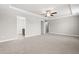 Spacious main bedroom with a tray ceiling, ceiling fan and neutral carpeted floors at 33 E Ravano Dr, Clayton, NC 27527