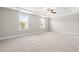 Sun-filled main bedroom featuring a tray ceiling, ceiling fan, neutral decor and plush carpeting at 33 E Ravano Dr, Clayton, NC 27527