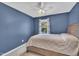 A charming bedroom featuring a comfy bed, ceiling fan, and a window with sheer curtains at 342 Westgrove Ct, Durham, NC 27703